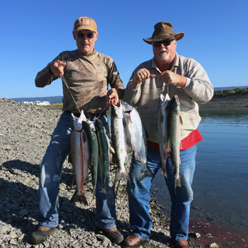 Jeff Strahan and David Strahan sampling the saltwater coho fishery in the Nick Dudiak Fishing Lagoon on the Homer Spit