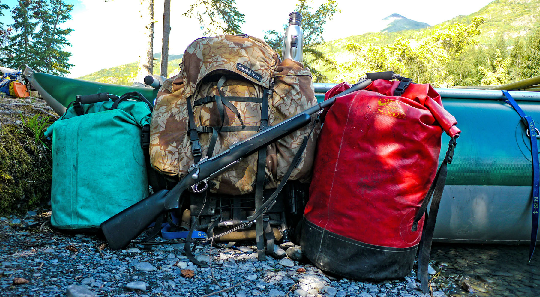 dry bags, pack, and rifle for an Alaska float hunt