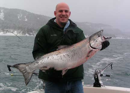 man with fat winter king salmon